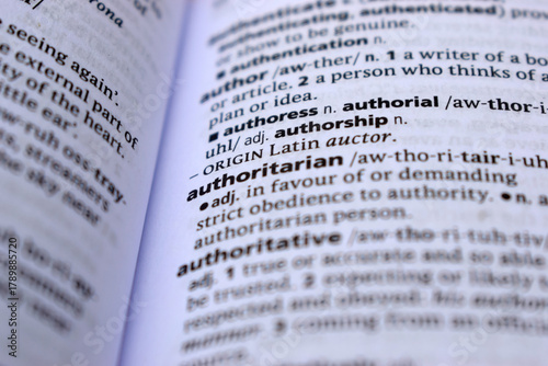 Close Up Of English Dictionary Page With Word - authoritarian
