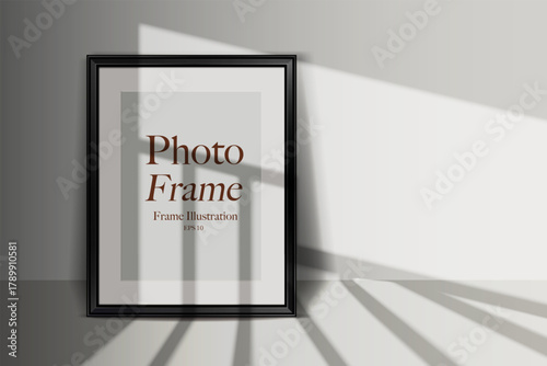 Black photo frame mockup leaning on a wall. Realistic shadow and light effect.