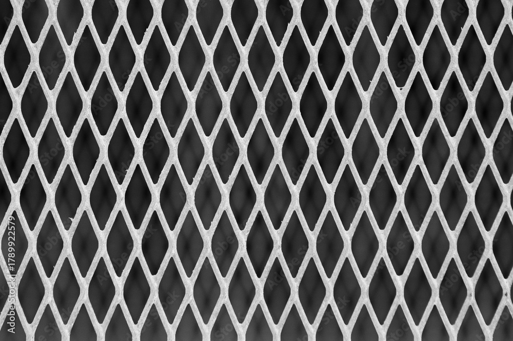 Fototapeta premium gray metal mesh on a dark gray background