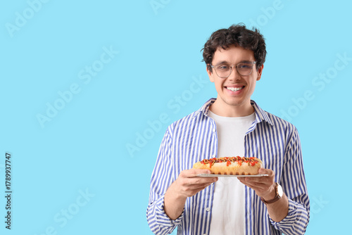 Young man with tasty hot do...