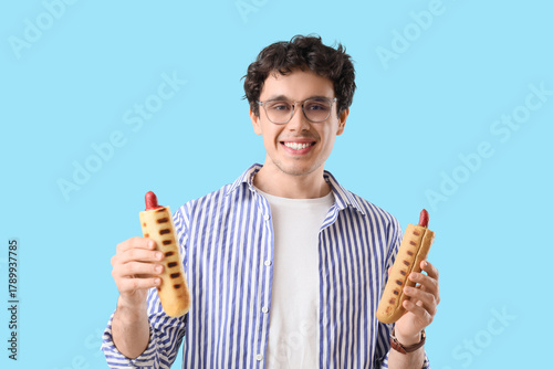 Young man with tasty hot do...