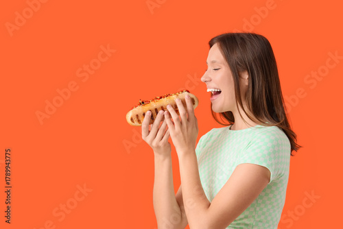 Young woman eating tasty ho...