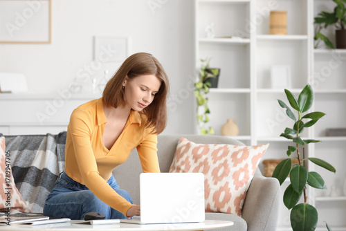 Young woman using modern la...
