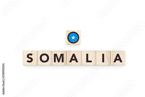 Wooden blocks bearing the name and flag of Somalia. Somali and African Culture, national identity, travel, and geography in a copy space design.