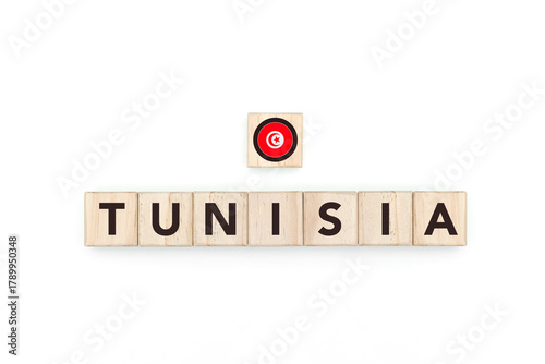 Wooden blocks bearing the name and flag of Tunisia. Tunisian and African Culture, national identity, travel, and geography in a copy space design.