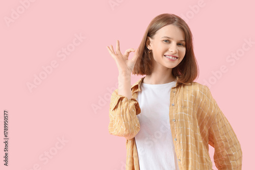 Young woman showing OK on p...