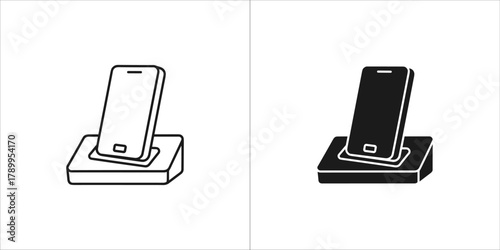 Two icon style illustrations of a smartphone on a charging dock, one outlined and one solid black
