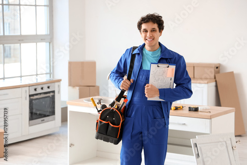Male worker with tool bag a...