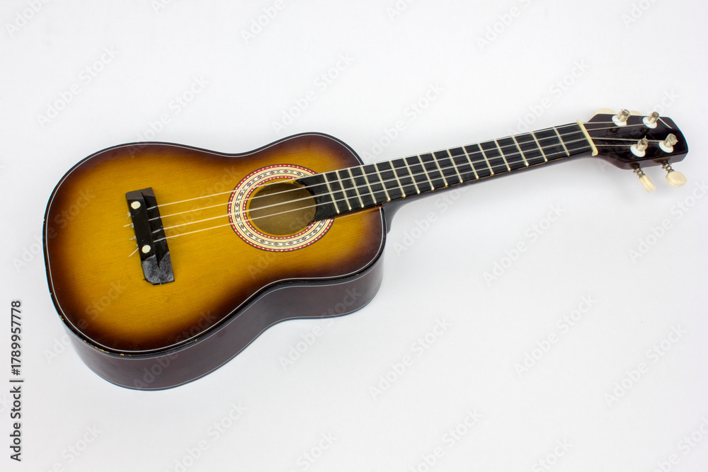 Fototapeta premium Ukulele isolated on white background with copy space, a compact instrument for musical expression