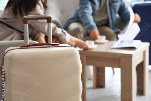 Suitcase against couple wit...