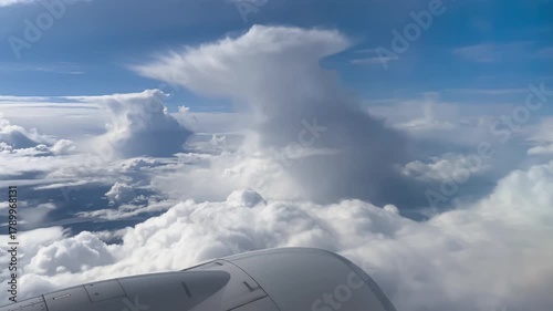 Airplane flight. Wing of an airplane flying above the clouds. View from the window of the plane