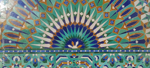 Moroccan zellige mosaic with intricate green and blue geometric pattern. hassan ii mosque