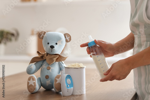 Woman with baby milk formul...