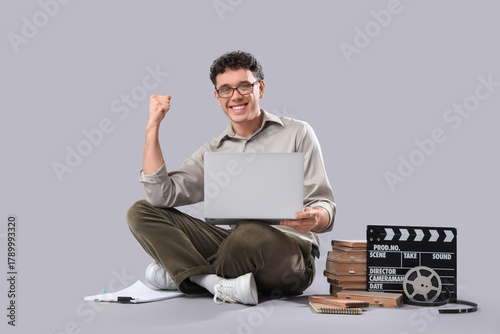Happy male screenwriter wit...