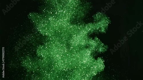 Green Glittering Cloud Forming Against Black Background