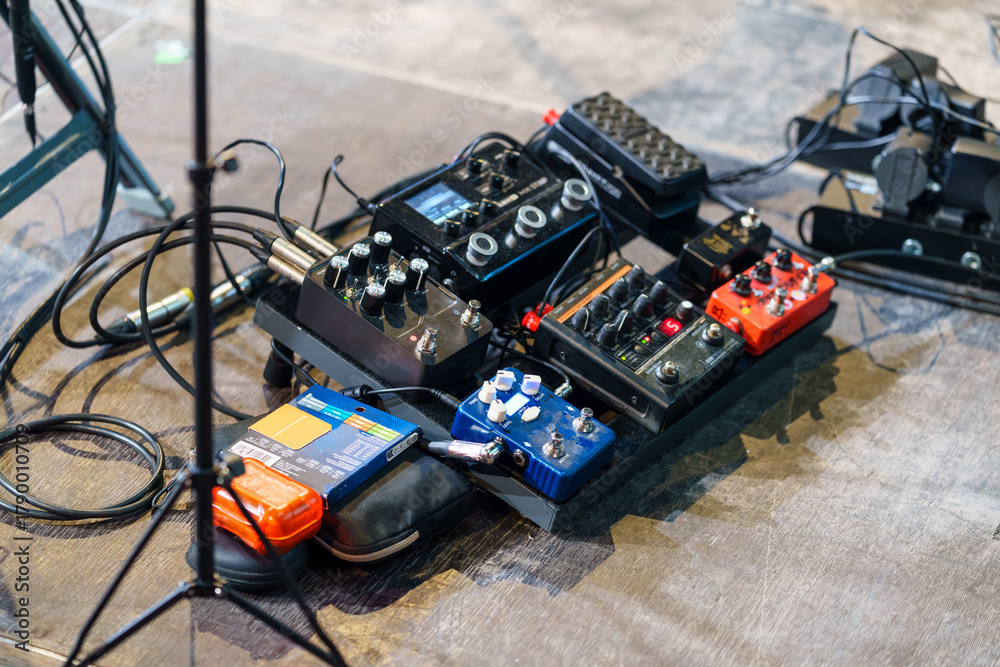 Naklejka premium Electric guitar control pedals arranged on the stage, used by musicians to create sound effects and modify tone during live performances