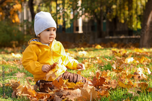 Cute little baby with leave...