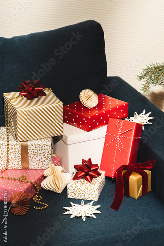 Many Christmas gifts on blue sofa