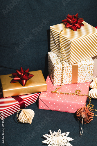 Many Christmas gifts on blue sofa