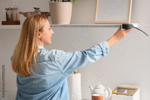 Mature woman measuring shel...