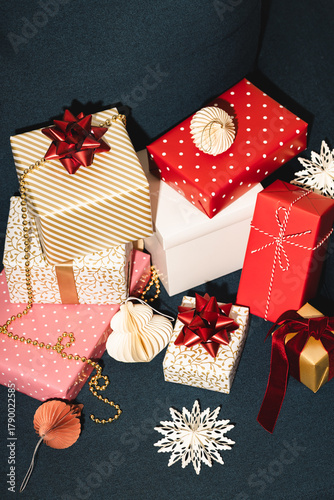 Many Christmas gifts on blue sofa