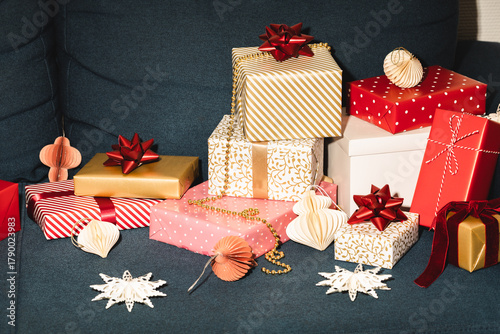 Many Christmas gifts on blue sofa