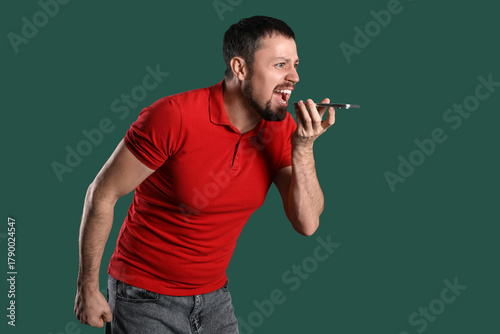 Young man screaming at mobi...