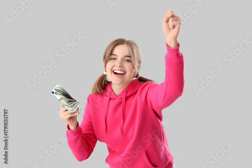 Happy young woman with mone...