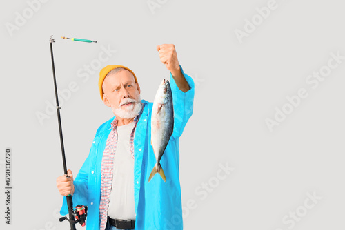 Senior man with fishing rod...