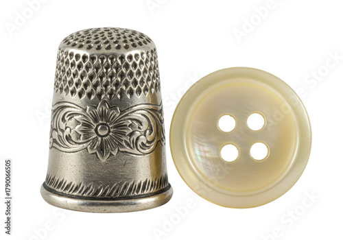 Billede på lærred Isolated Sewing notions, a thimble and mother-of-pearl button for needlework and