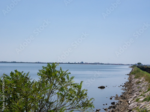 Grado, Italy - July 30th 2024: Dam towards the touristic village of Grado behind the lagoons and islands