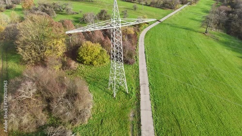 Aerial View of High Voltage Power Line Tower in Green Landscape