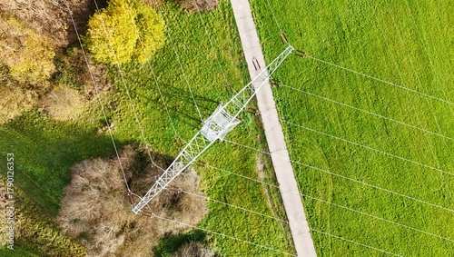 Aerial View of High Voltage Power Line Tower in Green Landscape