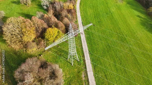Aerial View of High Voltage Power Line Tower in Green Landscape