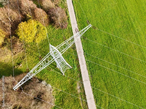 Aerial View of High Voltage Power Line Tower in Green Landscape