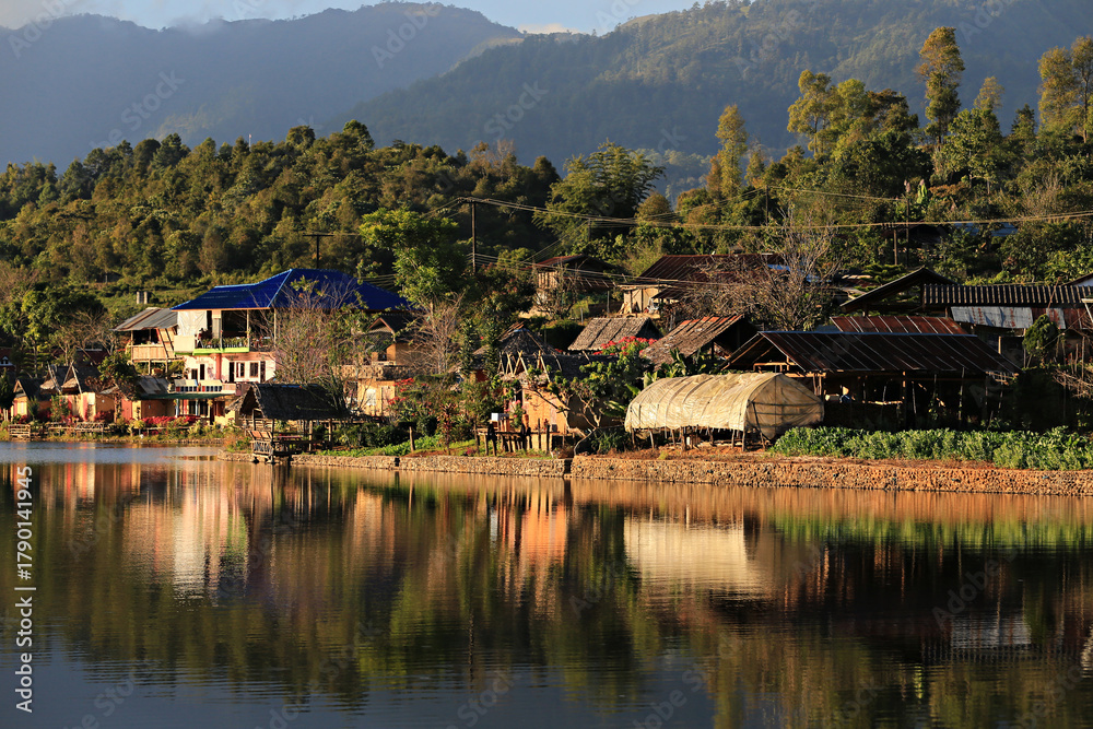 Fototapeta premium Ban Rak Thai (Mae Aw) Beautiful Tranquil Village in Mae Hong Son Province, Thailand, Rak Thai Village reflection in Richpool at Mae Hong Son, Thailand