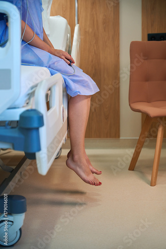 Woman patient on hospital bed with oxygen tubes in room