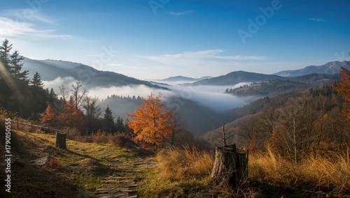Fototapeta Naklejka Na Ścianę i Meble -  View over valley in high mountains shrouded in autumn morning fog, seasonal change