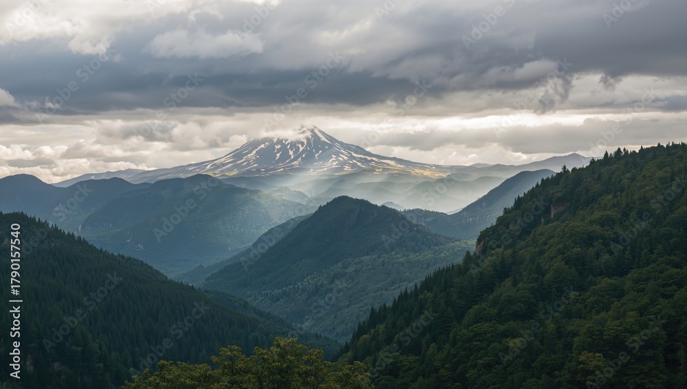 Fototapeta premium A distant view of mountains under a cloudy sky, showcasing erosion risk