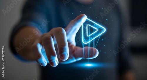 Hand touching a glowing blue digital play button interface