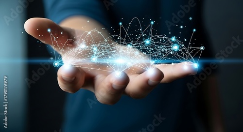 Hand holding exploding digital particles and light streaks