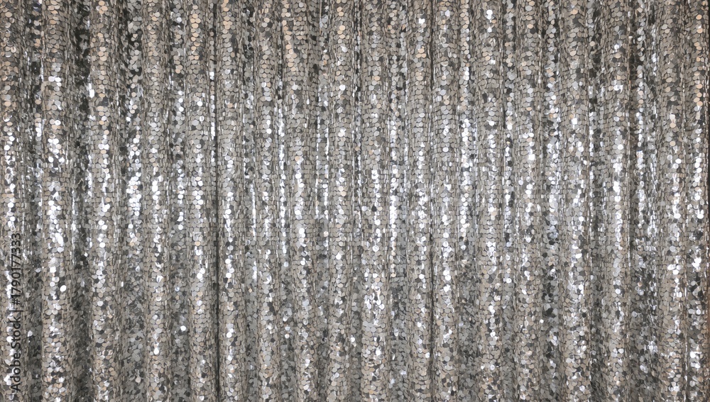 Obraz premium Silver sequin drapes serve as curtains and backdrops, reflecting light with a glossy finish, ideal for editorial header backgrounds