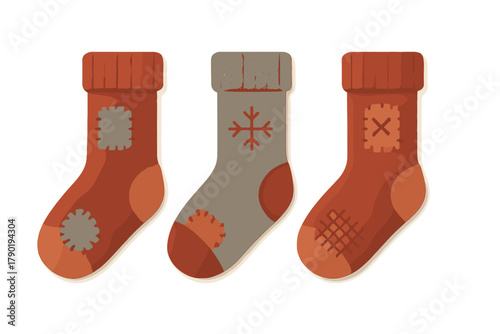 Three knitted winter socks with patches and snowflake pattern