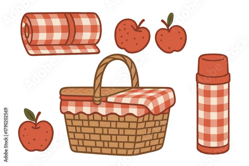 Wicker picnic basket with fresh apples and rolled blanket