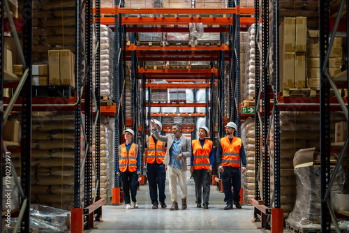 Warehouse manager leading team through logistics facility