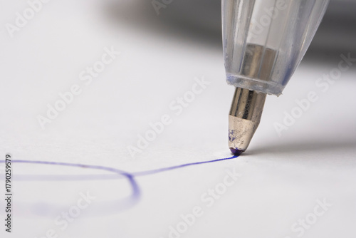 Close up of silver ballpoint pen on white background