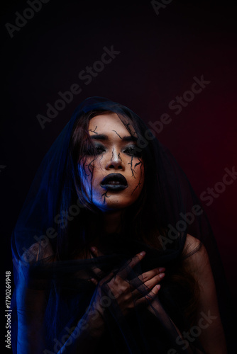 Mysterious Asian woman in dark veil portrait