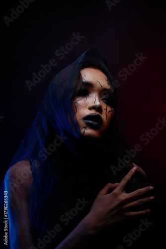 Emotional dark fashion portrait of Asian model