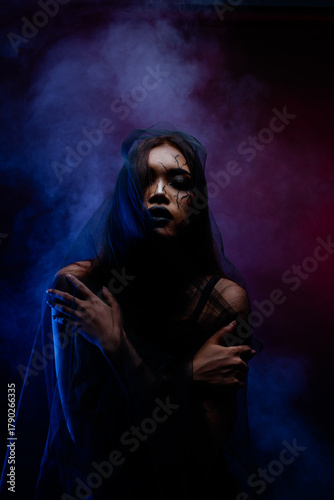 Dramatic dark beauty portrait of Asian woman