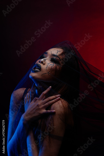 Artistic dark beauty portrait of Asian woman